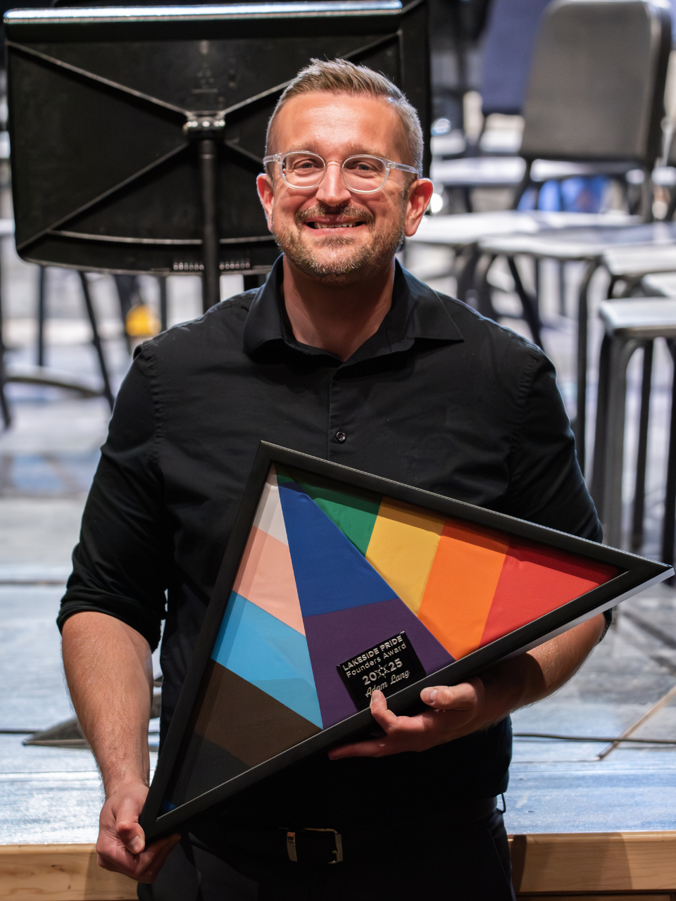 Adam Lang holding his Founders Award